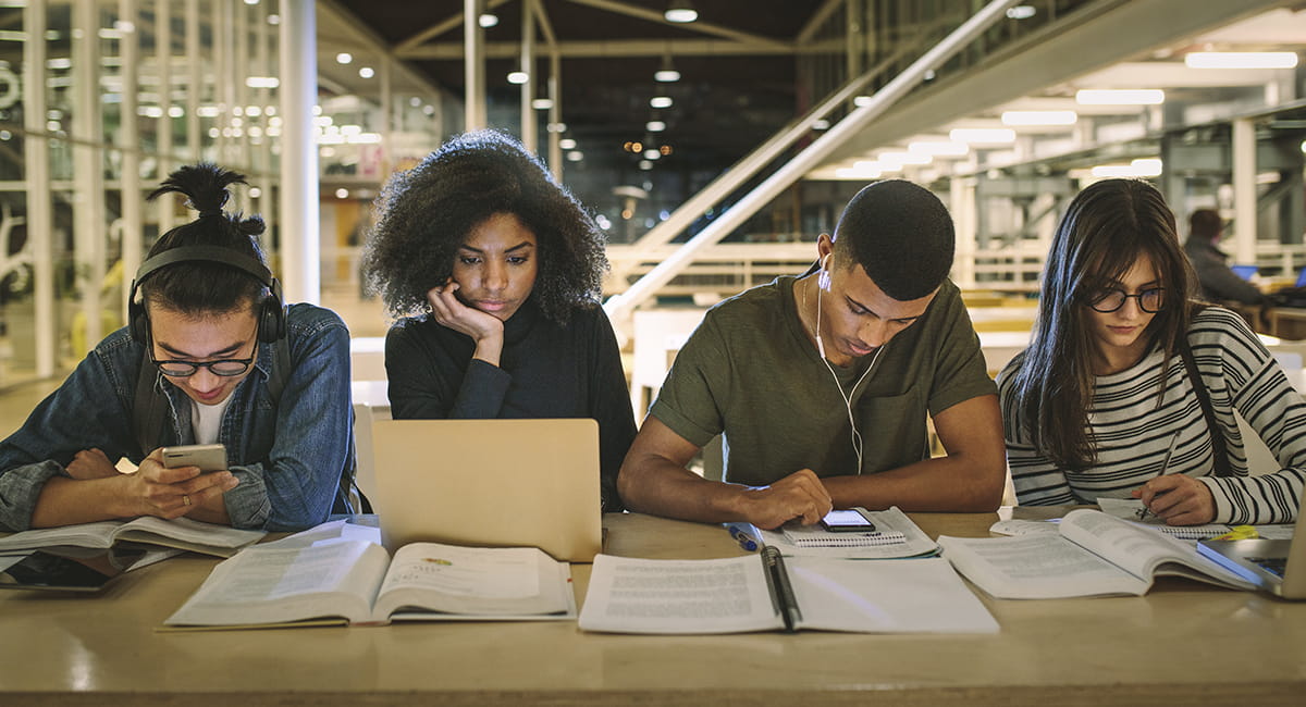 Students reading and studying in library