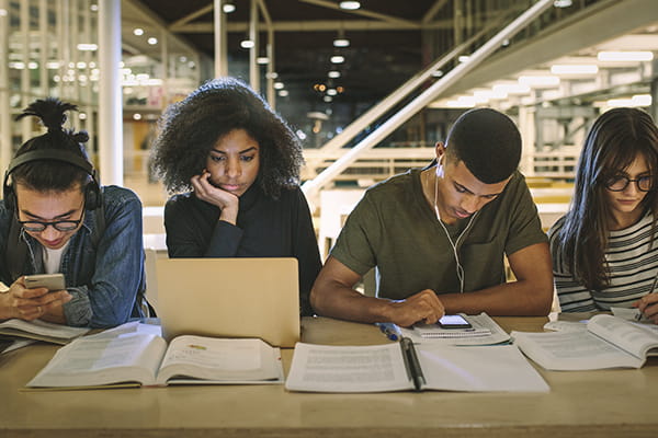 Students reading and studying in library